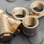 Metallic hex coupler fittings in brass on black